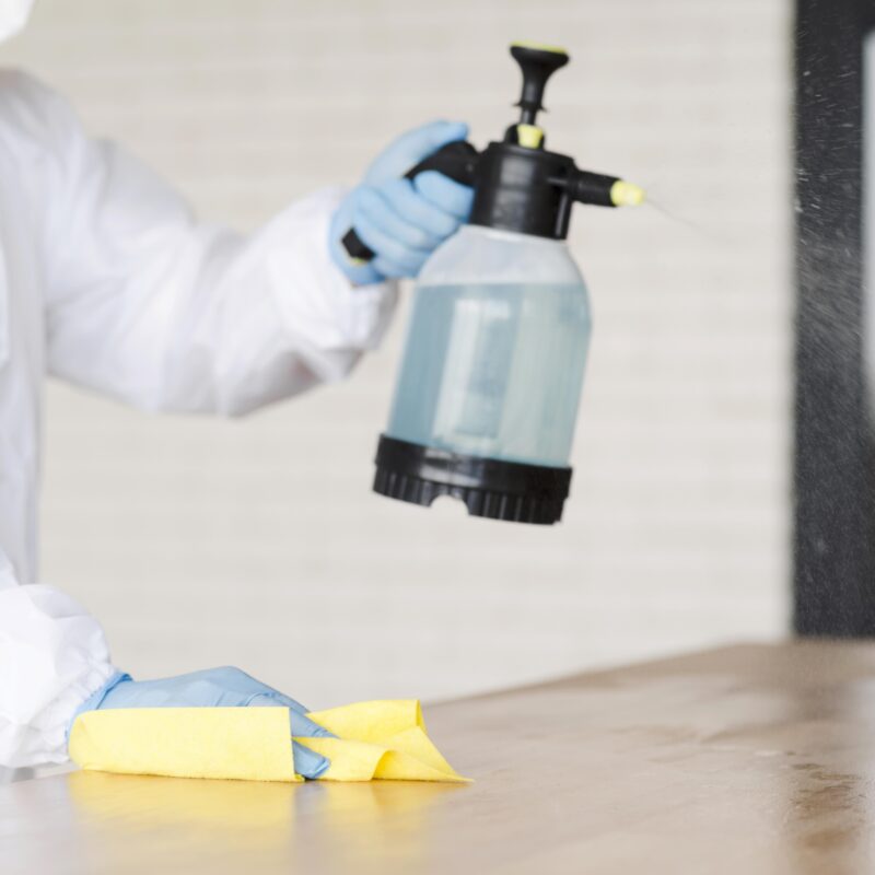 close-up-man-holding-disinfectant-bottle